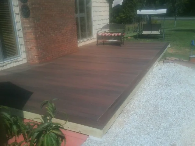 Freshly stained wood deck built against a brick home in Mount Pocono