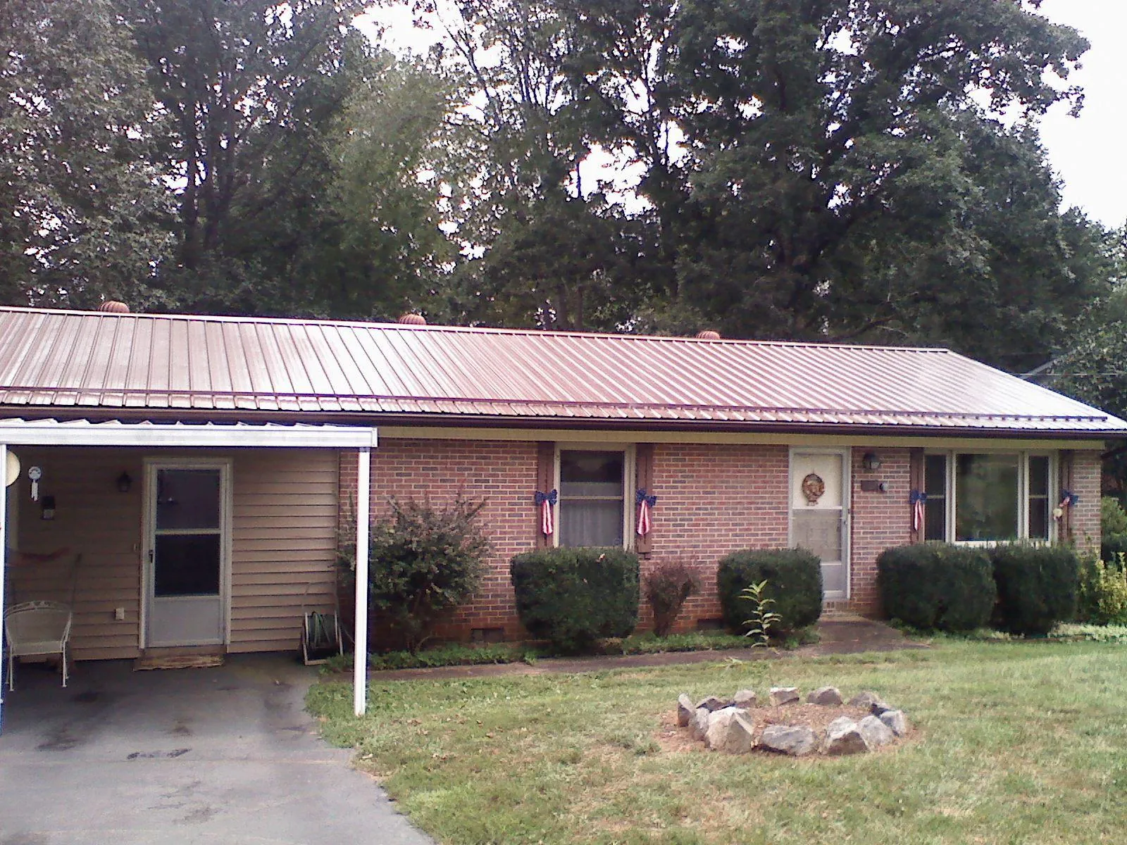 Bronze metal roof and carport on a brick ranch home — Roof Repair work by our crew in Mount Pocono