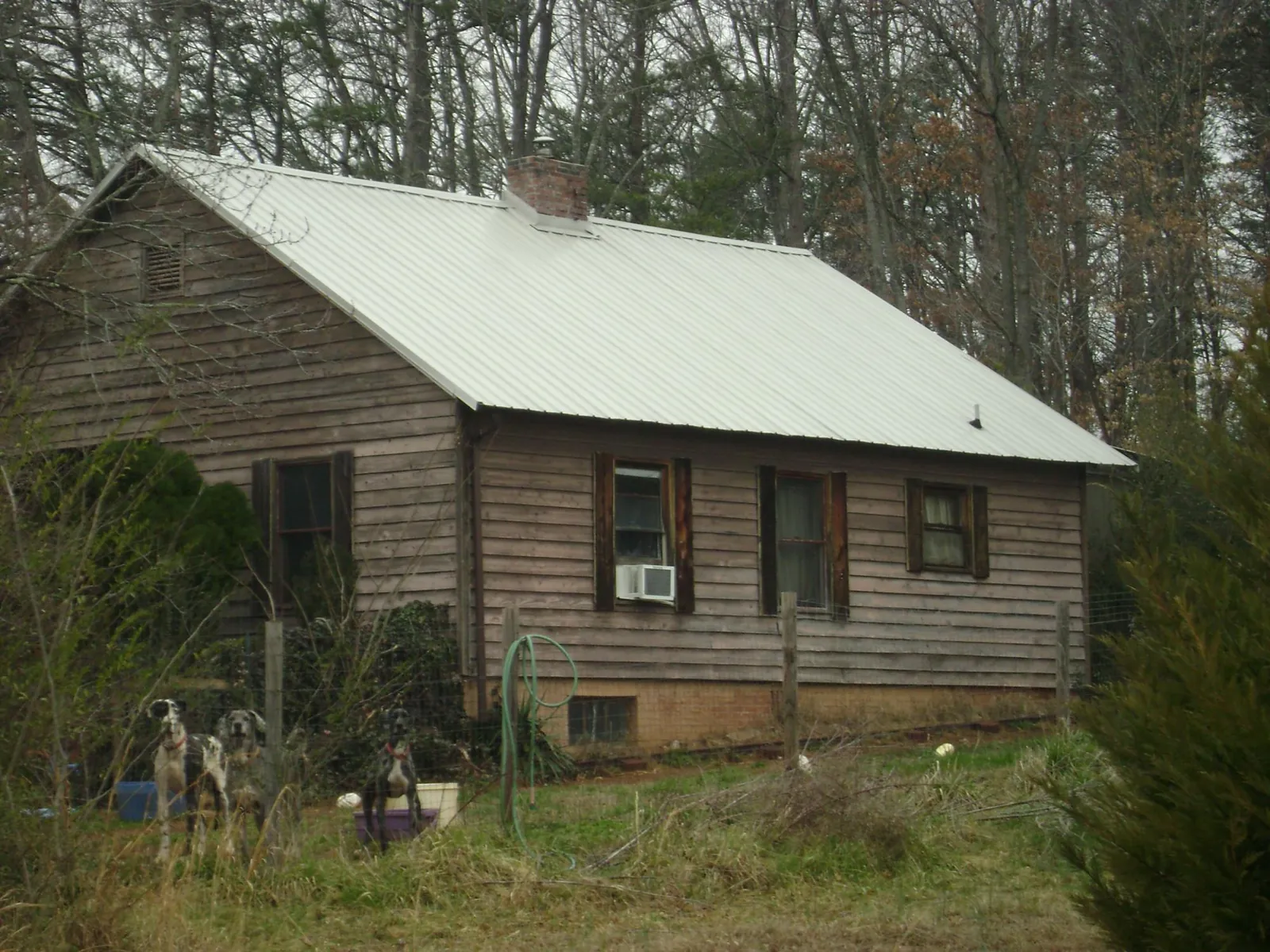 White metal roof on an old wood sided farmhouse, from a Metal Roof Installation job in Mount Pocono